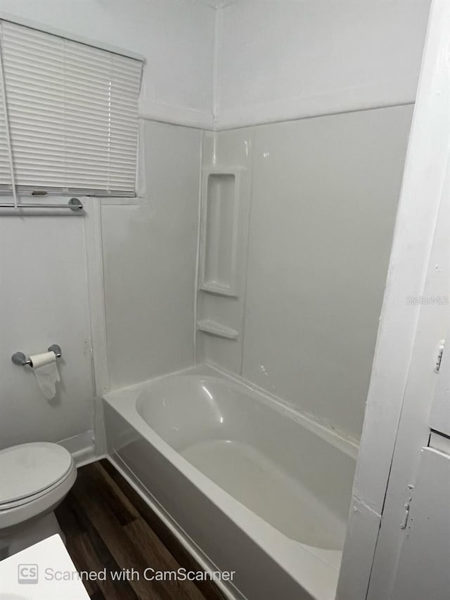 bathroom featuring hardwood / wood-style floors, toilet, and shower / bathing tub combination