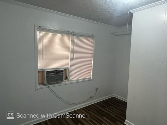 spare room with crown molding, a textured ceiling, wood-type flooring, and cooling unit