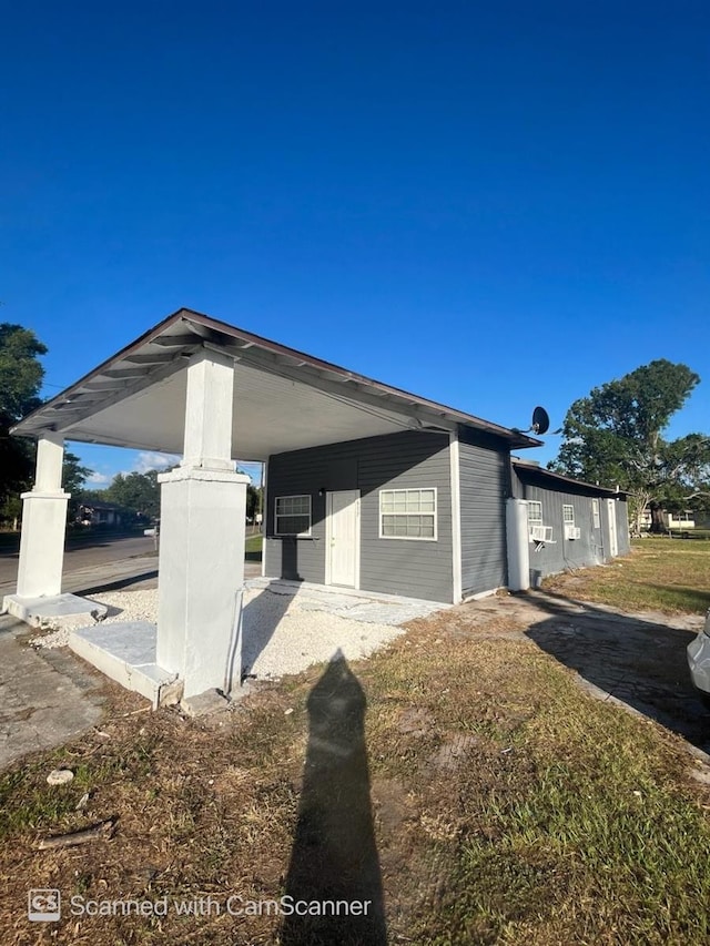 view of side of home with a carport