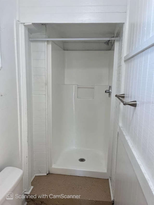 bathroom featuring toilet and a shower