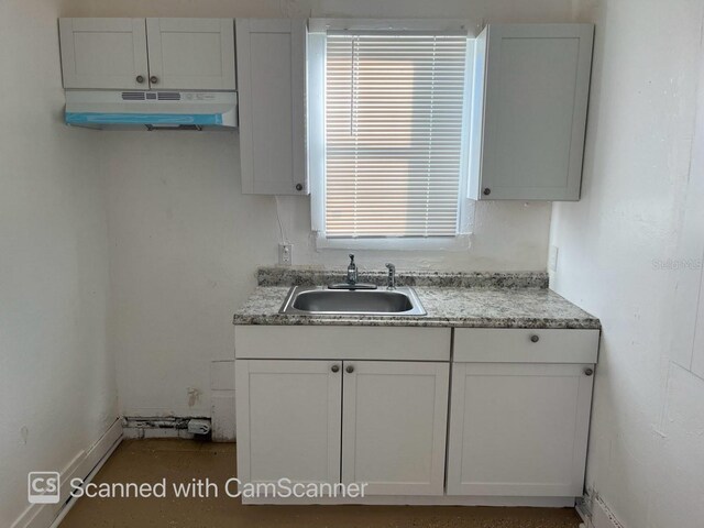 kitchen featuring sink and white cabinets