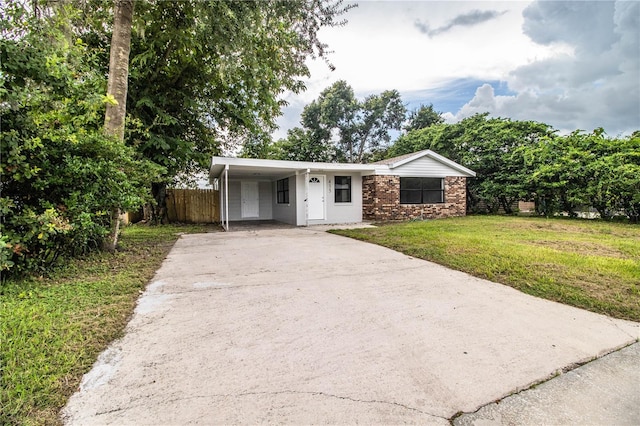 ranch-style house with a front yard and a carport