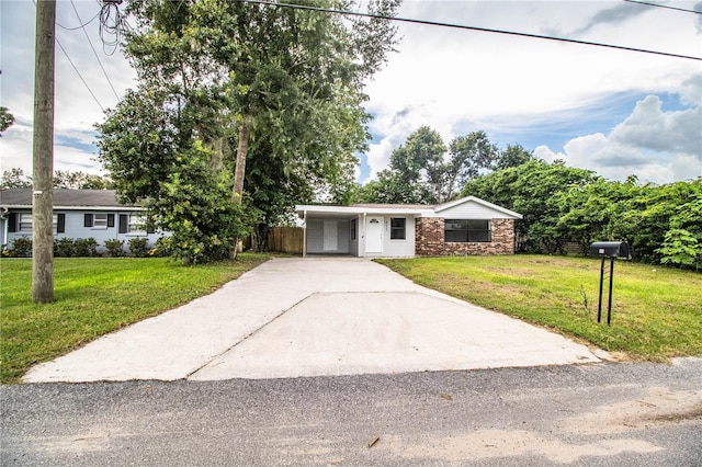 single story home featuring a carport and a front lawn