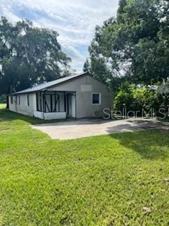 rear view of property with a patio area and a yard