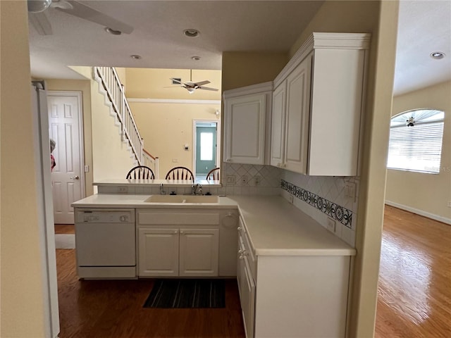 kitchen featuring ceiling fan, white cabinets, white dishwasher, and a healthy amount of sunlight