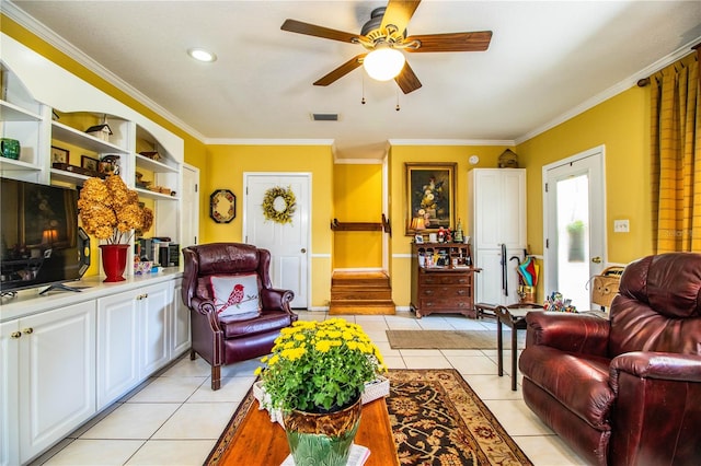 living room with ceiling fan, crown molding, and light tile patterned flooring