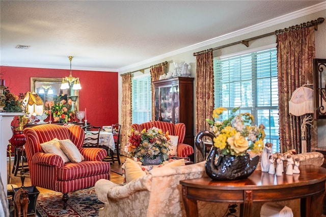 living room featuring crown molding and a notable chandelier