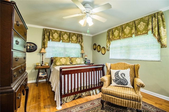 bedroom featuring ceiling fan, crown molding, and dark hardwood / wood-style floors