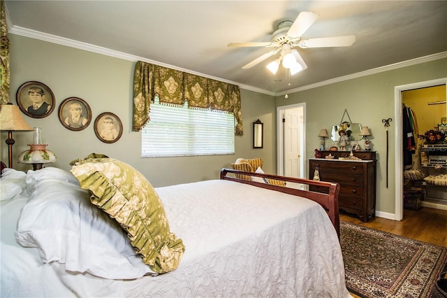 bedroom featuring ceiling fan, wood-type flooring, and crown molding