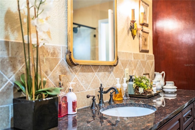 bathroom featuring vanity and backsplash