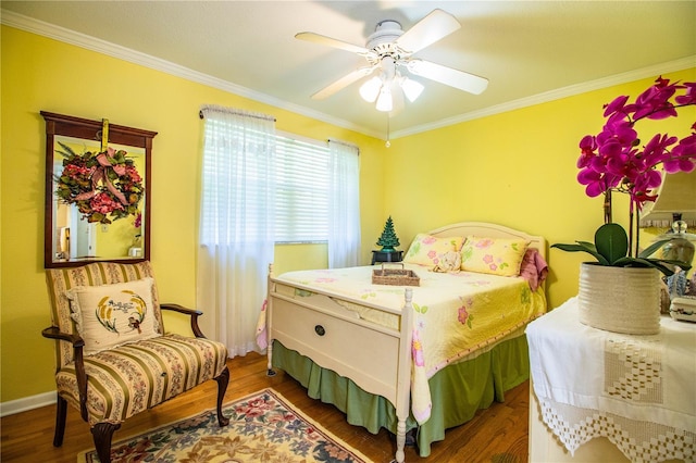 bedroom with dark hardwood / wood-style floors, ceiling fan, and ornamental molding