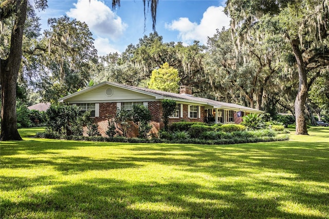 single story home with a front lawn