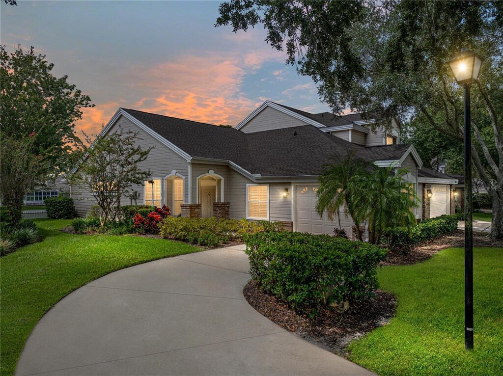 view of front of property featuring a garage and a yard