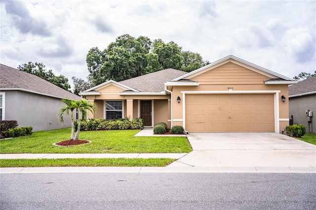 single story home featuring a garage and a front yard