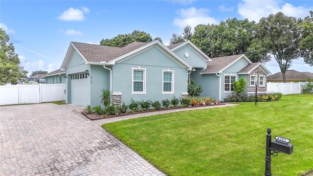 view of front of home featuring a garage and a front lawn