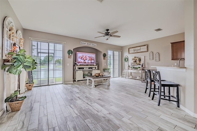 dining area with light hardwood / wood-style floors and ceiling fan