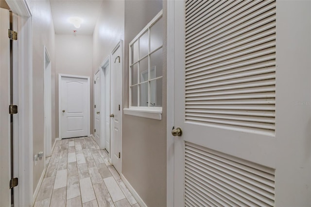 hallway with light hardwood / wood-style floors