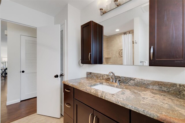 bathroom featuring vanity, hardwood / wood-style floors, and walk in shower