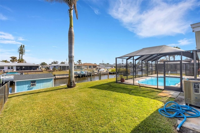 view of yard featuring a water view and a lanai