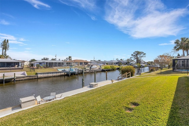 view of dock with a water view and a yard