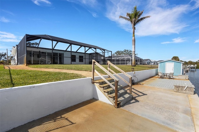 view of patio / terrace with a lanai and a water view