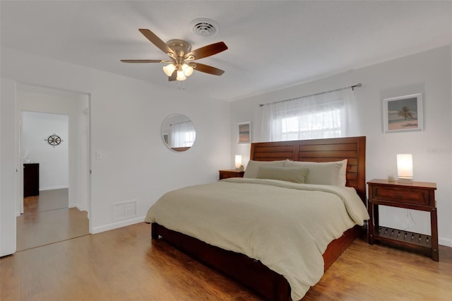 bedroom with ceiling fan and light wood-type flooring