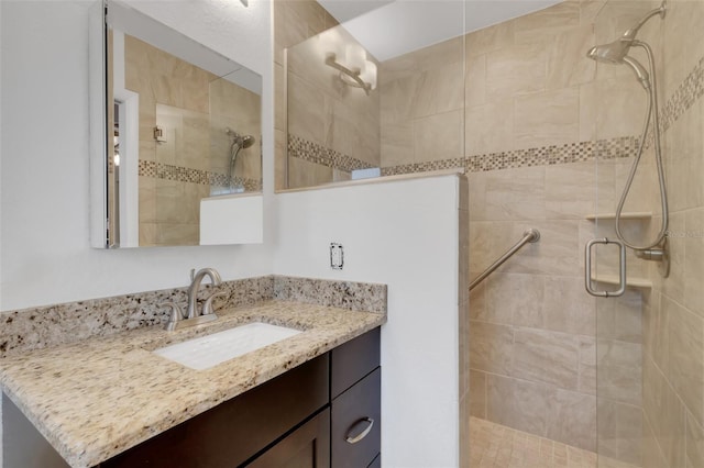 bathroom with walk in shower and vanity