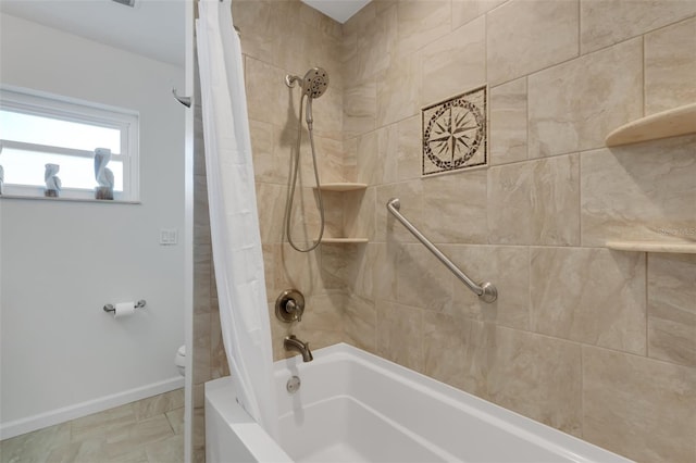 bathroom with toilet and shower / bath combo