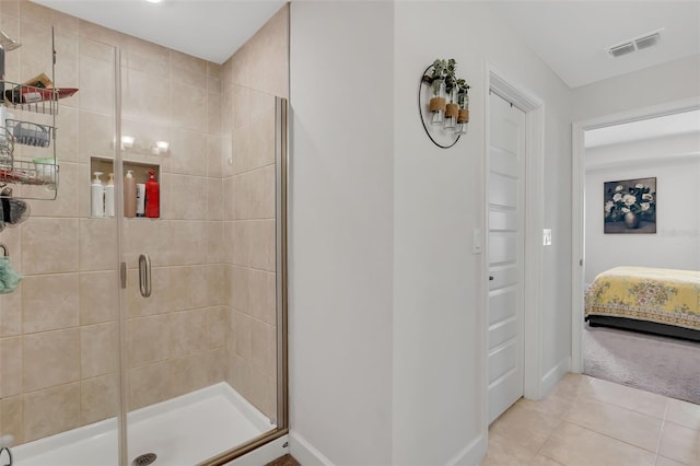 bathroom featuring a shower with door and tile patterned floors