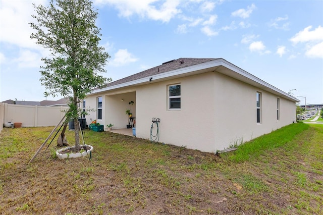 view of property exterior featuring a yard and a patio area