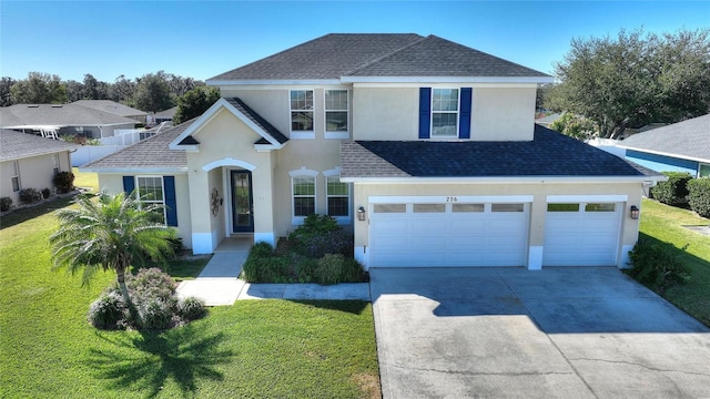 view of front of house featuring a garage and a front lawn