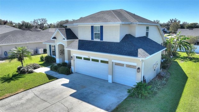 view of front of home featuring a garage, a front yard, and central air condition unit