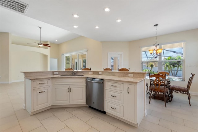 kitchen featuring sink, hanging light fixtures, an island with sink, and dishwasher