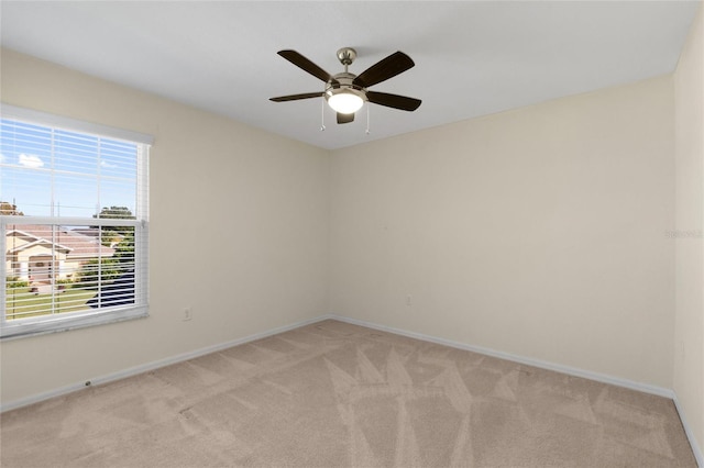 carpeted empty room featuring ceiling fan