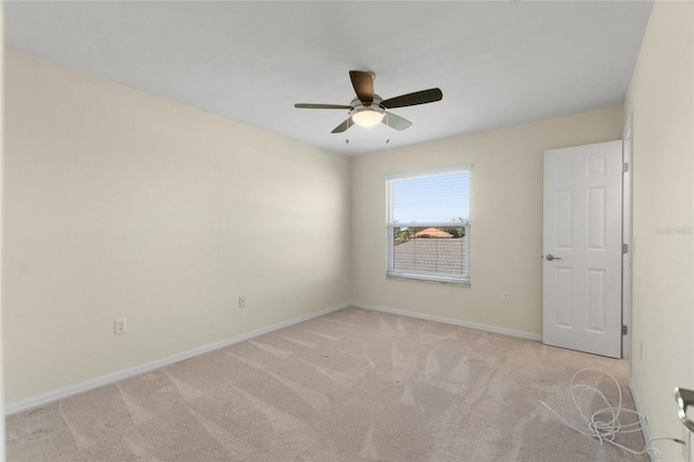 empty room with ceiling fan and light colored carpet