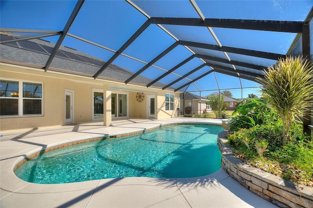 view of pool featuring a patio and glass enclosure