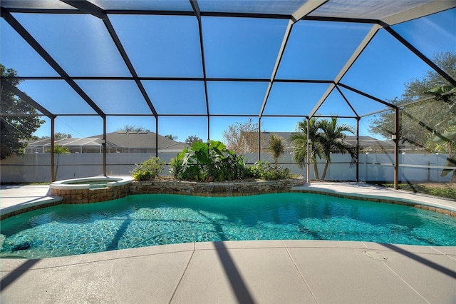 view of pool with an in ground hot tub, glass enclosure, and a patio