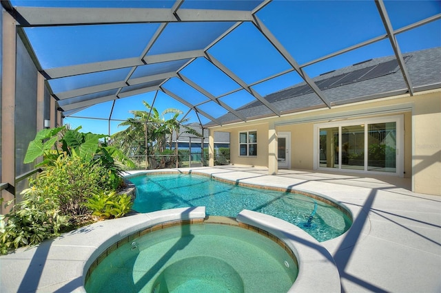 view of pool featuring an in ground hot tub, a lanai, and a patio