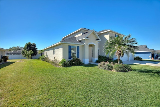 view of front of home featuring a garage and a front lawn