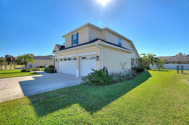 view of side of property featuring a yard and a garage