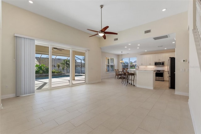 unfurnished living room with ceiling fan