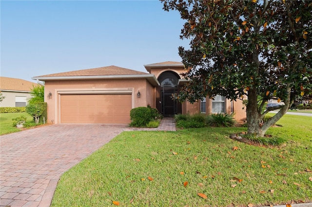 view of front of house with a garage and a front lawn