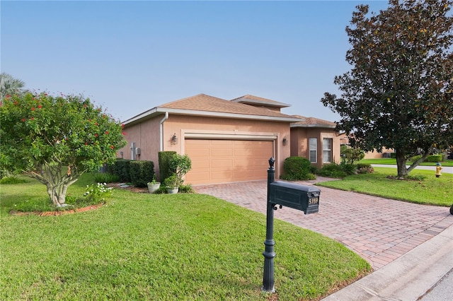 view of front of house featuring a garage and a front lawn