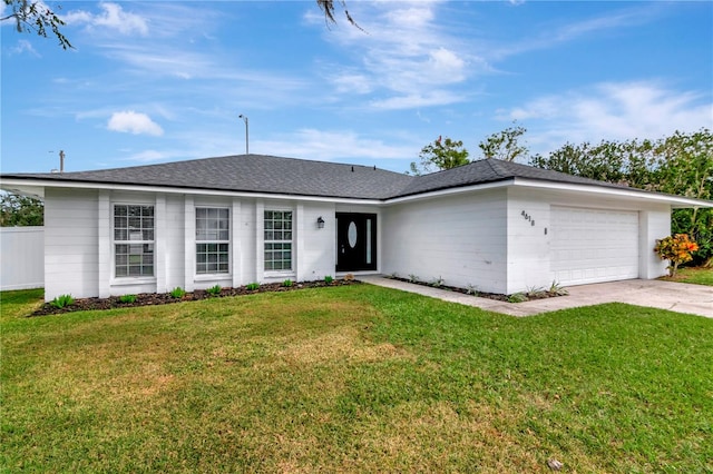 ranch-style home featuring a front lawn and a garage