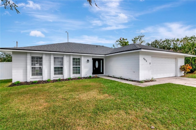 4618 Crestview Ln, Lakeland, FL 33813 - view of front of home with a garage, driveway, a front lawn, and roof with shingles