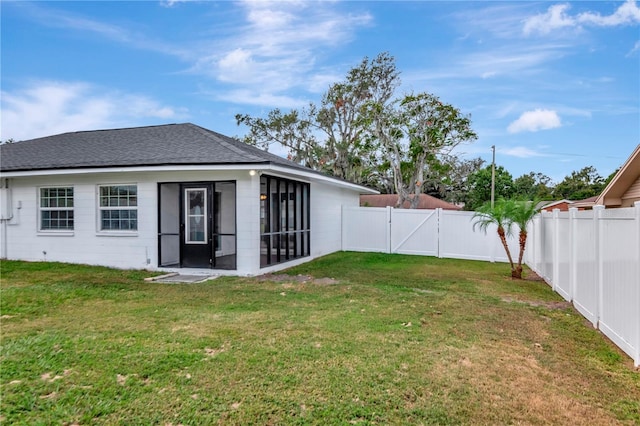 4618 Crestview Ln, Lakeland, FL 33813 - rear view of house with a sunroom, a shingled roof, a gate, and concrete block siding
