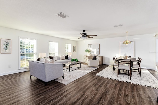 living room featuring ceiling fan and dark hardwood / wood-style flooring