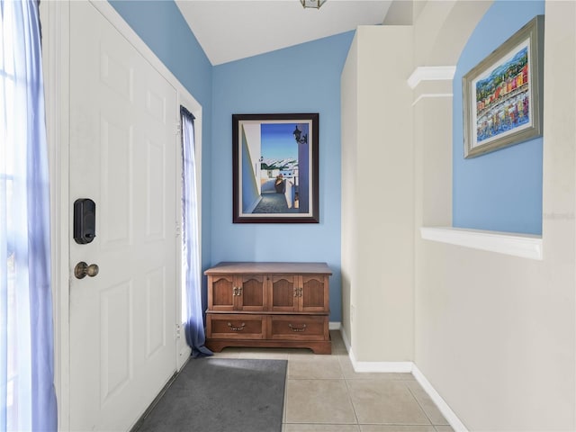 tiled entryway with vaulted ceiling