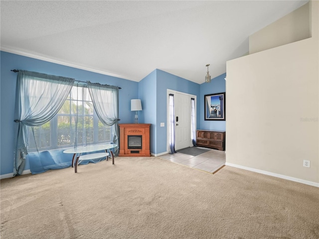 interior space featuring lofted ceiling, a textured ceiling, and light colored carpet