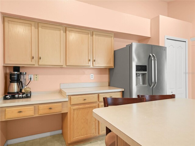 kitchen with stainless steel refrigerator with ice dispenser and light brown cabinets